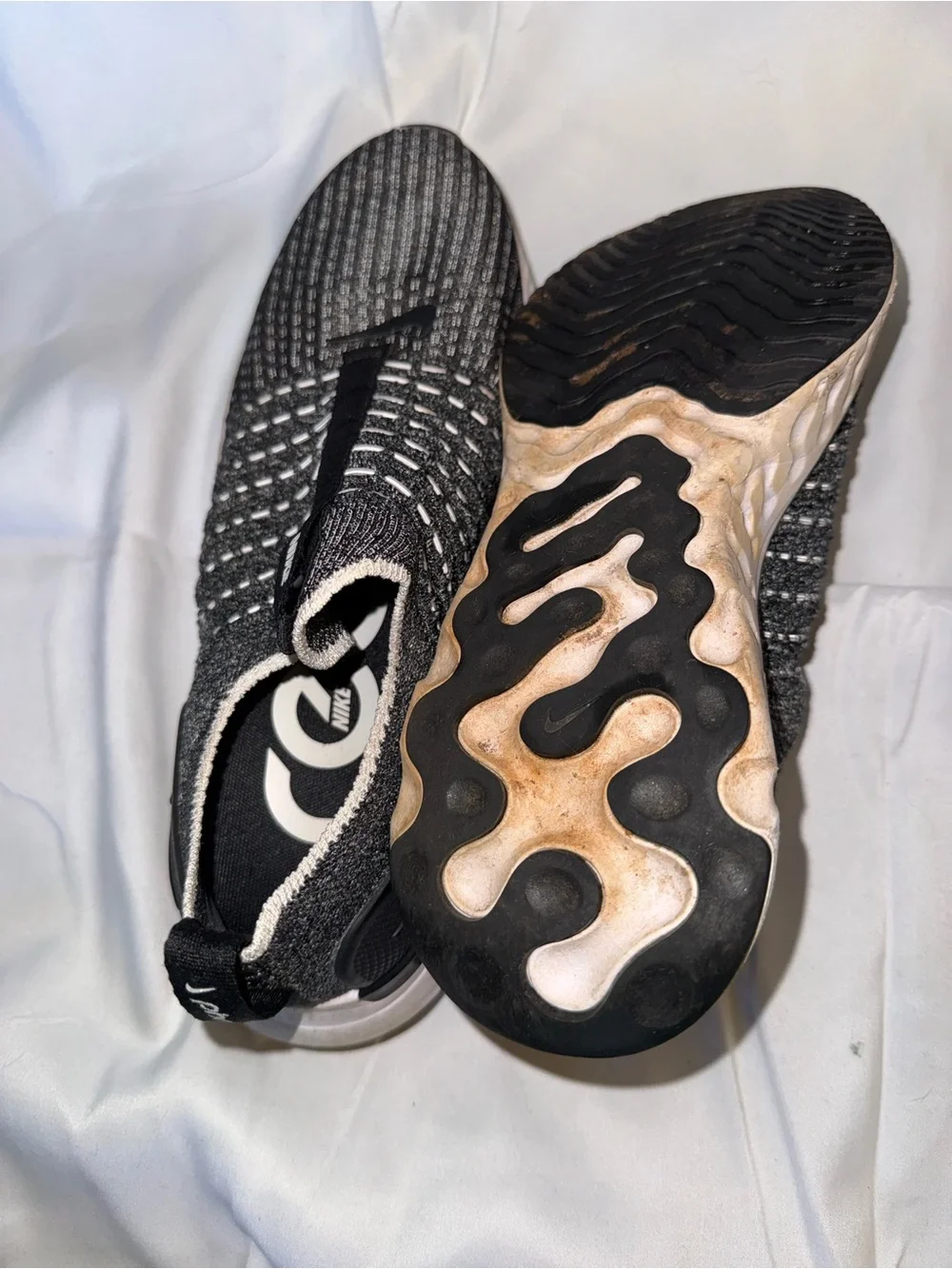 Nike women’s Black and Gray Knit Slip-On Sneakers